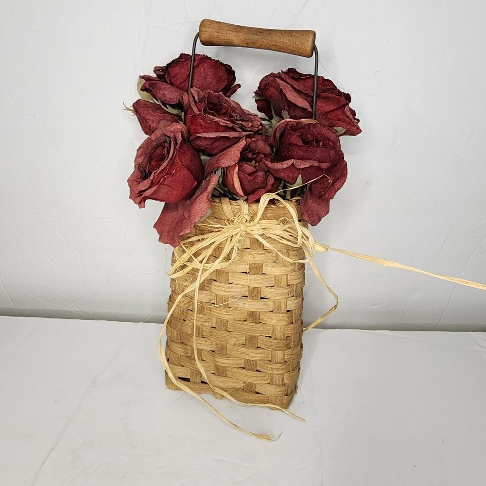 Handcrafted basket decorative with floral arrangement with handle